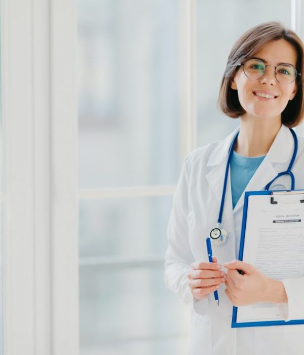 woman-doctor-stands-with-clipboard-fills-up-application-form-holds-pen-smiles-positively.jpg